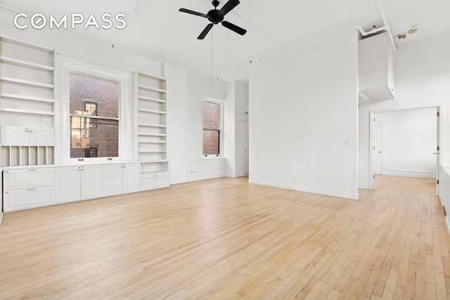 unfurnished living room with ceiling fan, built in features, baseboards, and light wood finished floors