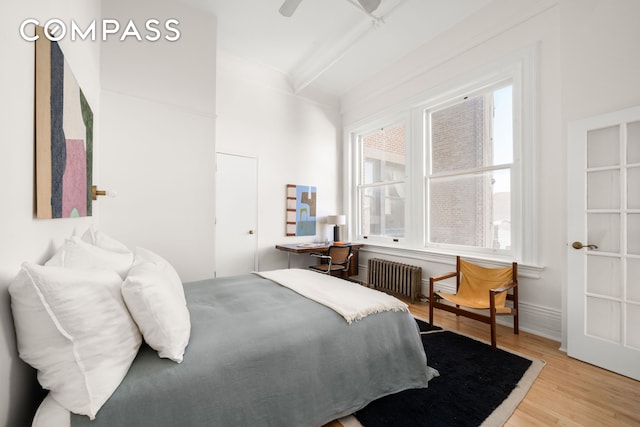 874 Broadway Unit 907, New York City, NY 10003 - bedroom with radiator heating unit, wood finished floors, ceiling fan, and beamed ceiling