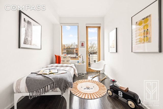 bedroom featuring baseboards and wood-type flooring
