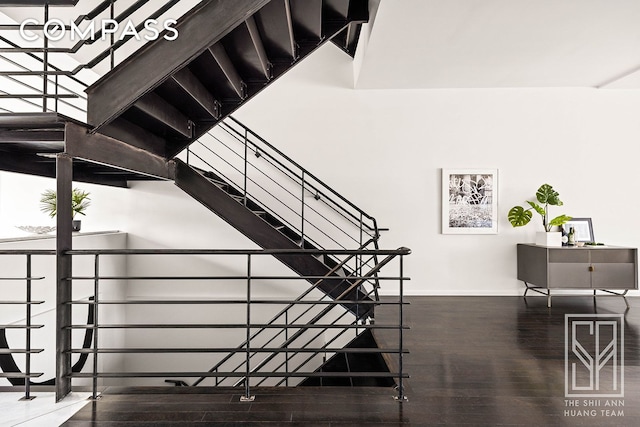 stairway with baseboards and wood finished floors