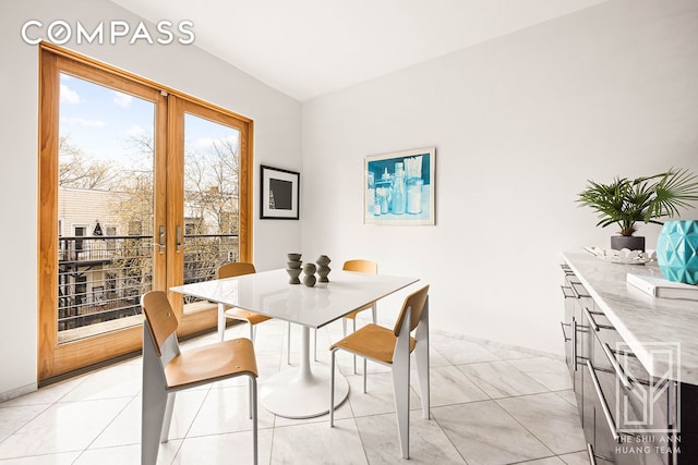 dining space with french doors and light tile patterned floors