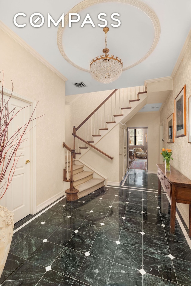staircase with crown molding, baseboards, and visible vents
