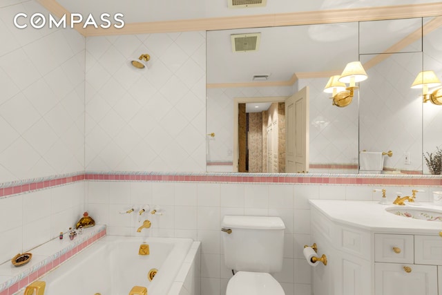 bathroom featuring tile walls, visible vents, and a jetted tub