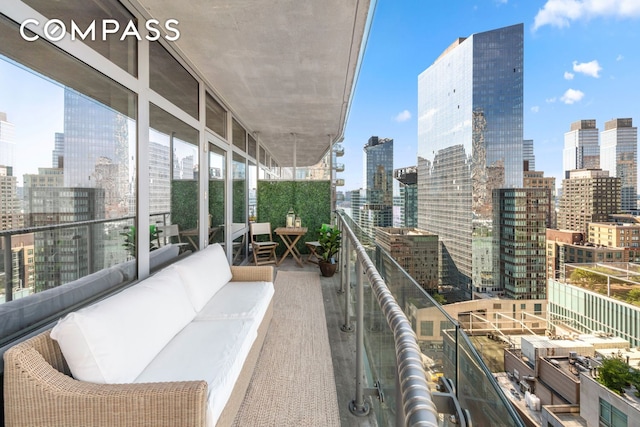 balcony featuring a skyline view and an outdoor hangout area