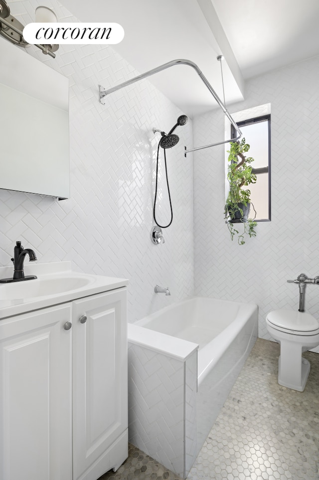 96 Arden St Unit 6K, New York City, NY 10040 - full bathroom with tile walls, bathing tub / shower combination, vanity, and toilet