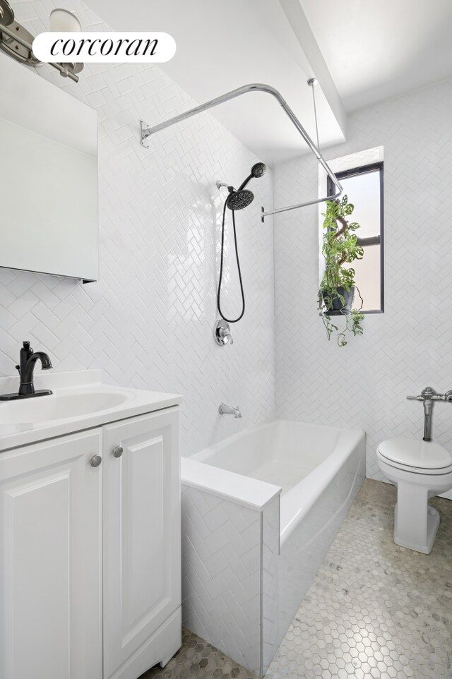 96 Arden St Unit 6K, New York City, NY 10040 - bathroom with tile walls, bathtub / shower combination, vanity, and toilet