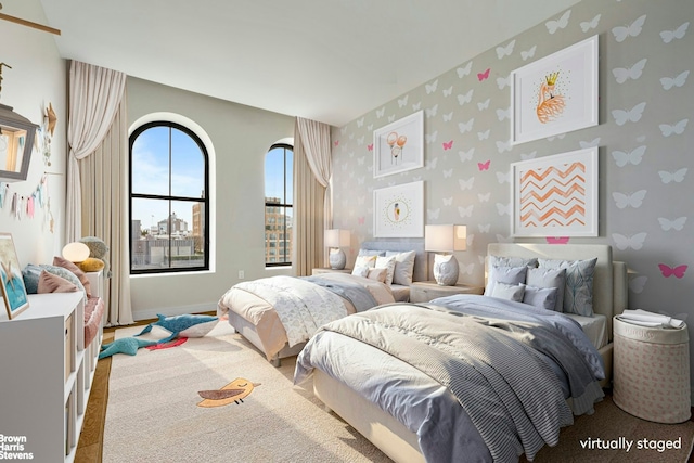 bedroom featuring wallpapered walls and baseboards