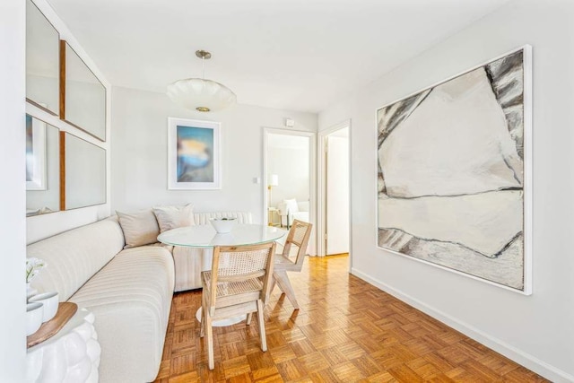 living area featuring baseboards