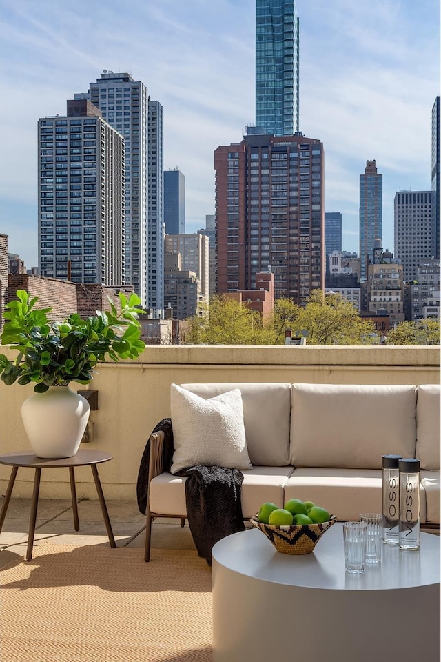 balcony featuring a view of city and outdoor lounge area