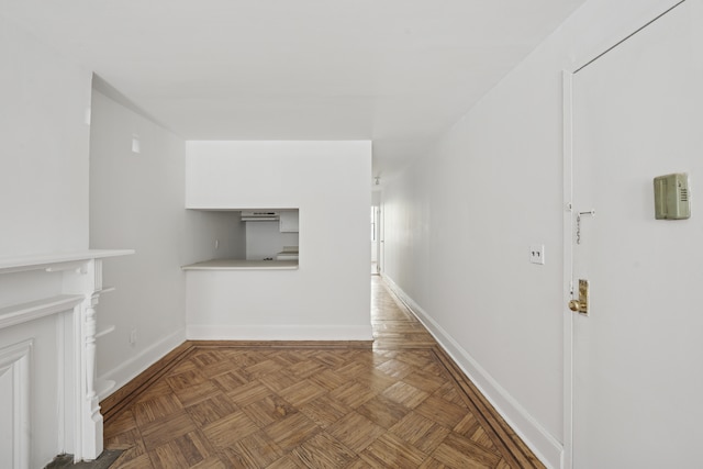 unfurnished living room featuring baseboards