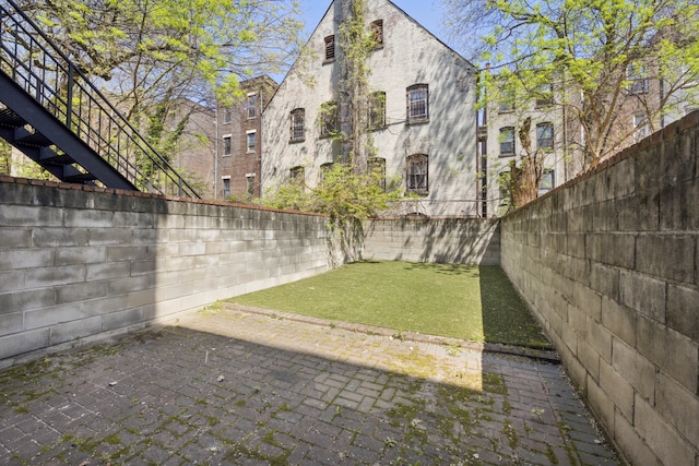 view of yard with a fenced backyard and a patio