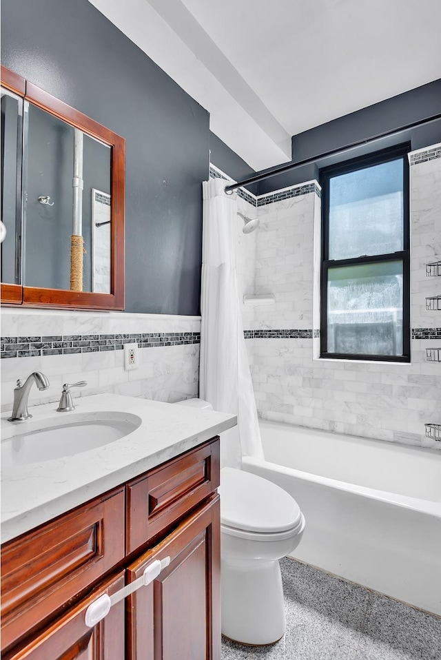 206 E 90th St Unit 4W, New York City, NY 10128 - full bath with tile walls, vanity, shower / bath combo with shower curtain, toilet, and wainscoting
