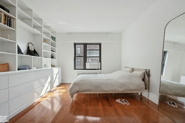 bedroom with hardwood / wood-style flooring