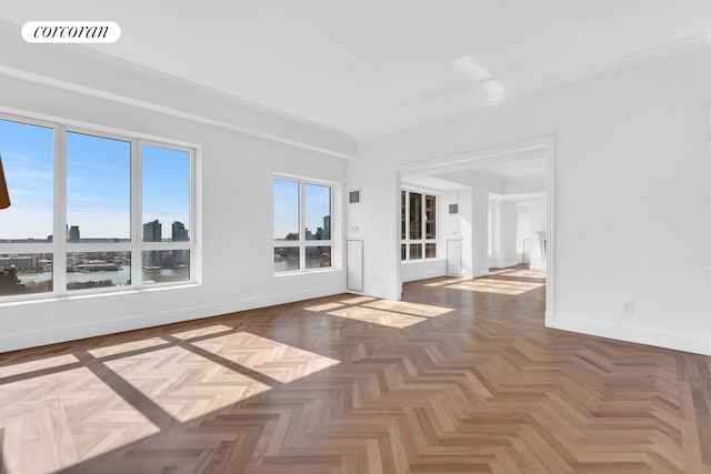 unfurnished room with crown molding, baseboards, and visible vents