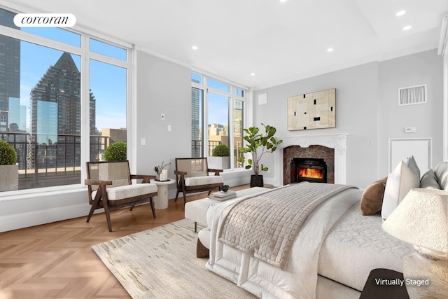 bedroom with visible vents, baseboards, a city view, recessed lighting, and a premium fireplace