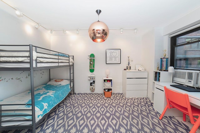 bedroom featuring carpet flooring and track lighting