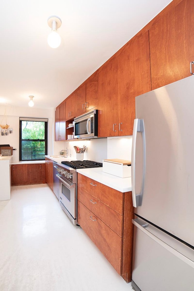 kitchen featuring light countertops, appliances with stainless steel finishes, and brown cabinets