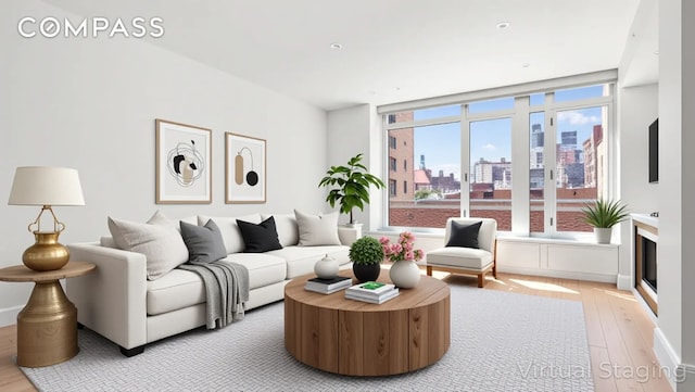 545 W 110th St Unit 5A, New York City, NY 10025 - living room featuring light wood finished floors and a skyline view