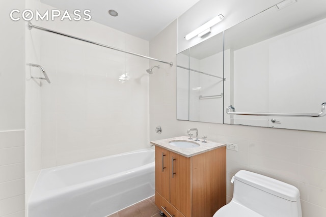 full bath with toilet, tile patterned floors, shower / bathing tub combination, and vanity