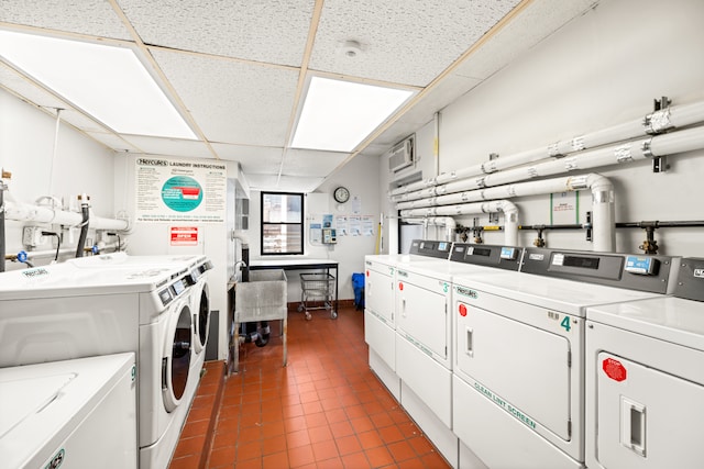 350 E 62nd St Unit 1J, New York City, NY 10065 - shared laundry room with washer and clothes dryer and dark tile patterned floors