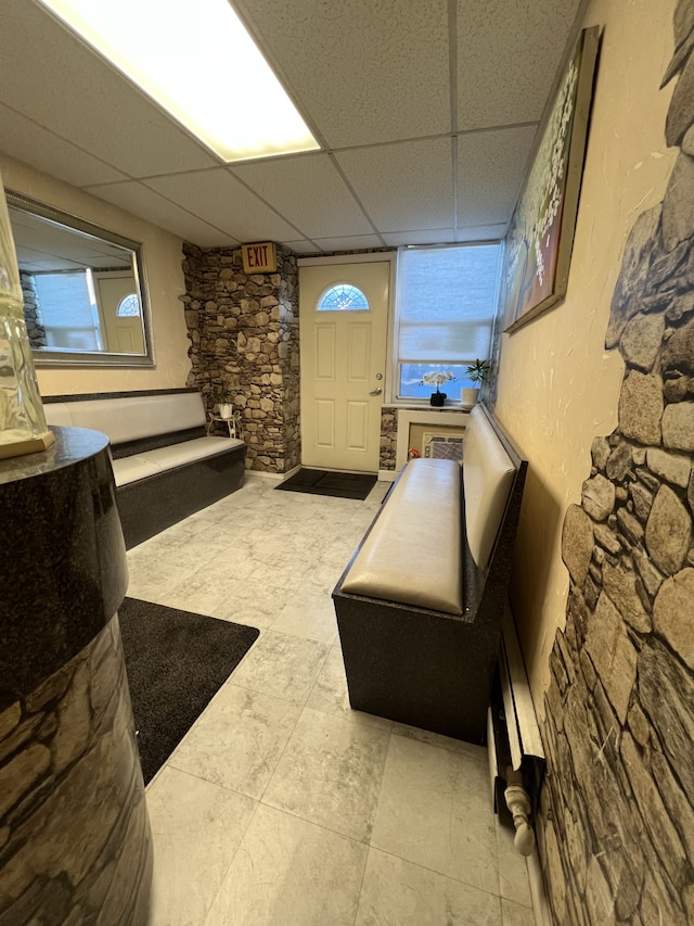 living area featuring a drop ceiling