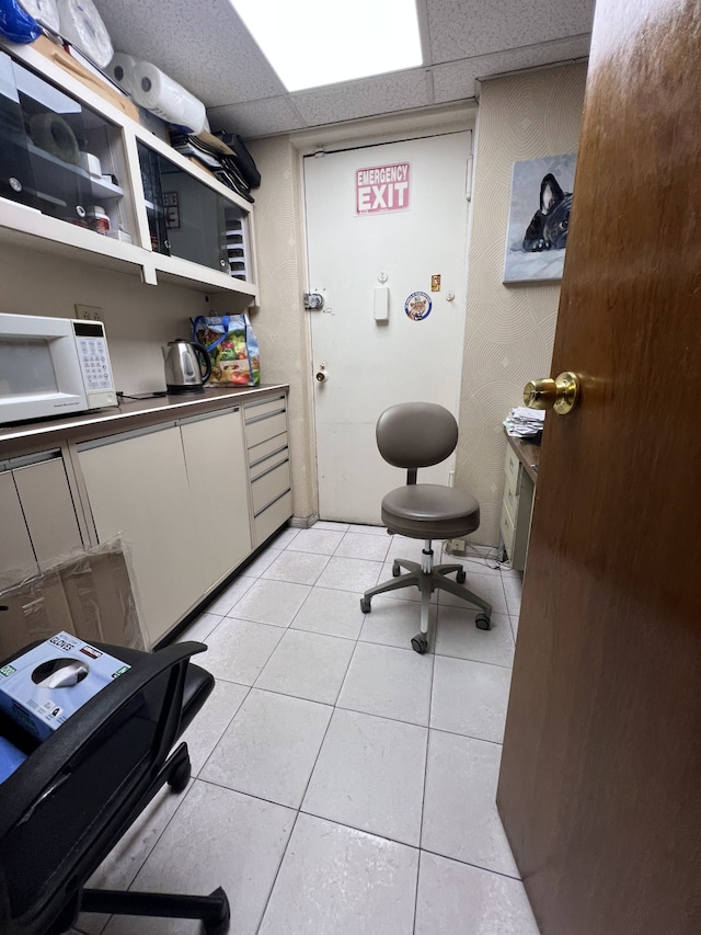 207 Ocean Pkwy Unit 1J, New York City, NY 11218 - office with light tile patterned floors and a paneled ceiling