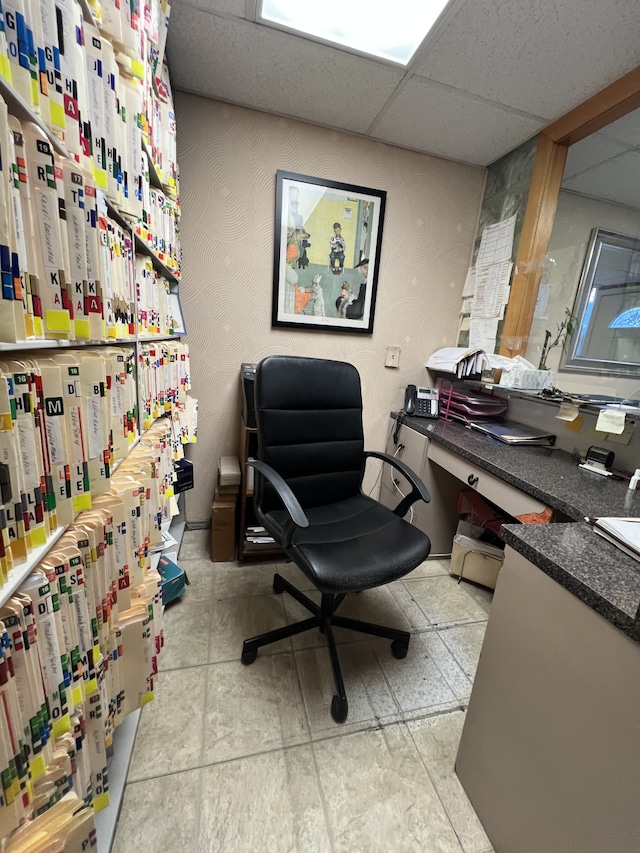 office area with a paneled ceiling