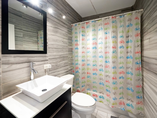 full bathroom with vanity, toilet, tile patterned floors, shower / bathtub combination with curtain, and tile walls