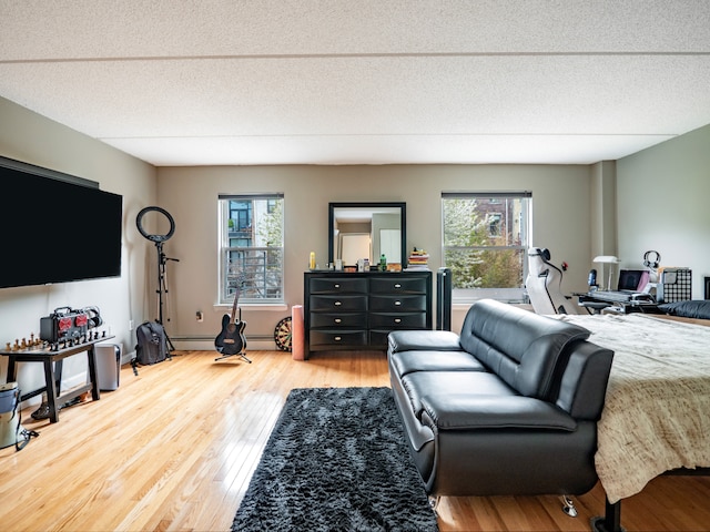 bedroom featuring a baseboard radiator and wood finished floors