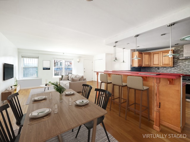 dining space with light wood-style flooring