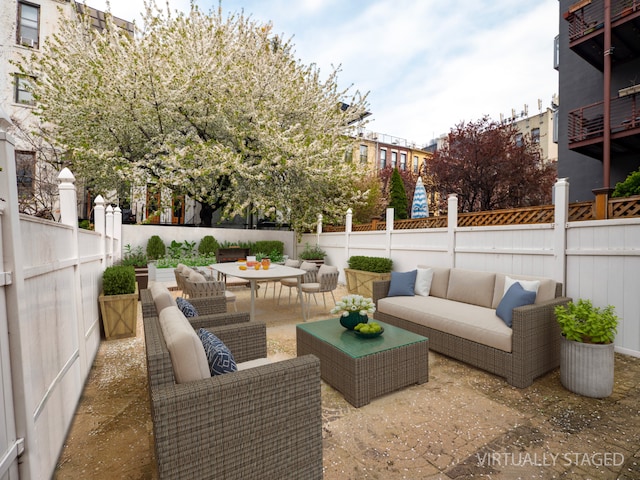 view of patio with fence and an outdoor hangout area