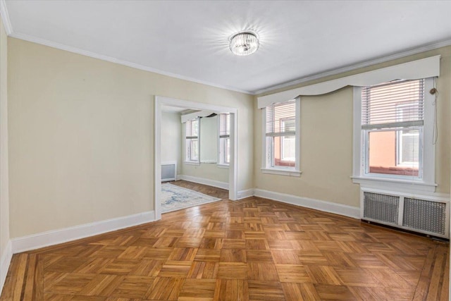 unfurnished room with crown molding, baseboards, and radiator heating unit