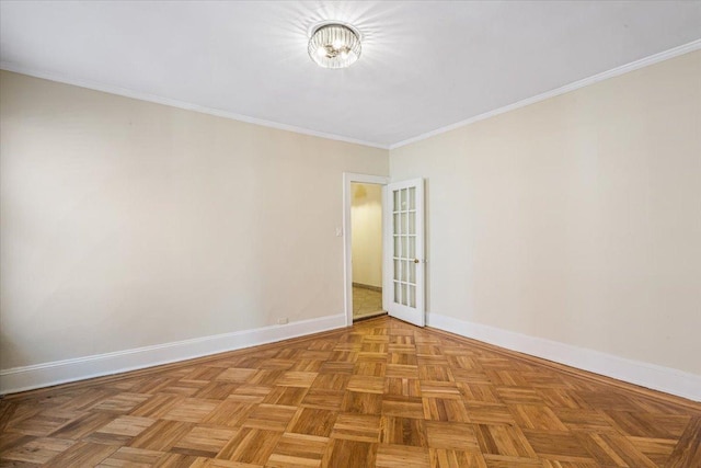 spare room featuring baseboards and crown molding