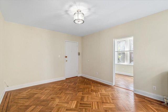 empty room featuring baseboards