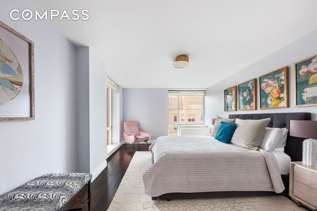 bedroom featuring baseboards and wood finished floors