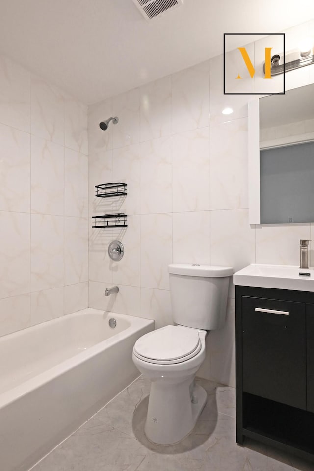 bathroom with visible vents, shower / tub combination, toilet, and tile walls