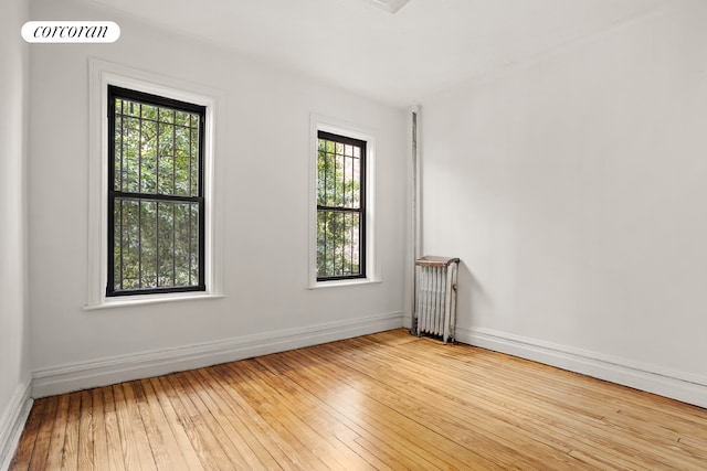 511 8th Ave, New York City, NY 11215 - empty room featuring baseboards, radiator heating unit, and hardwood / wood-style flooring