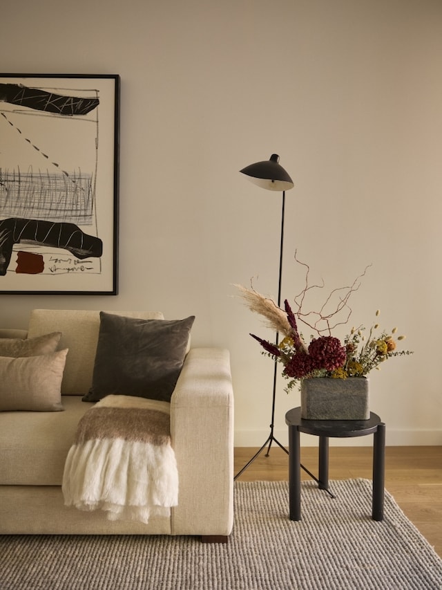 living area with baseboards and wood finished floors