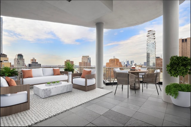 view of patio / terrace with a view of city, an outdoor living space, a balcony, and outdoor dining area