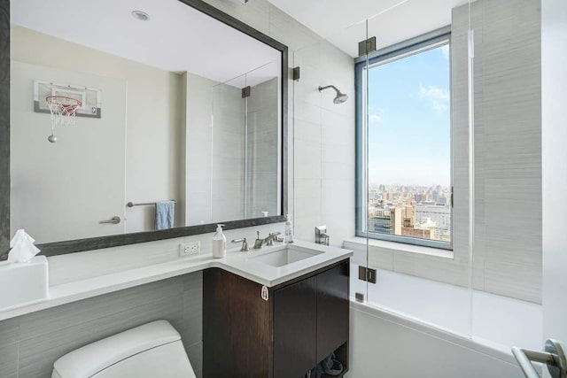 full bath featuring toilet, a shower with door, and vanity