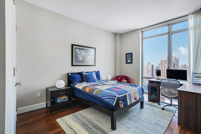 bedroom featuring baseboards and wood finished floors