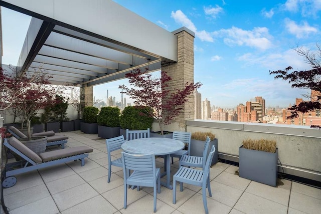 view of patio with a city view and outdoor dining area
