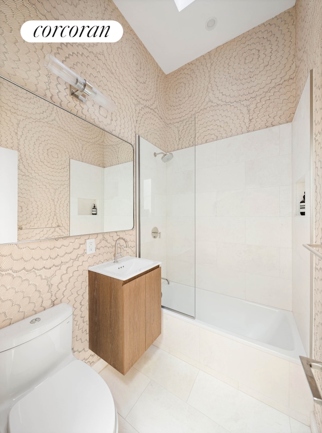 full bath featuring vanity, tile patterned floors, toilet, and tile walls