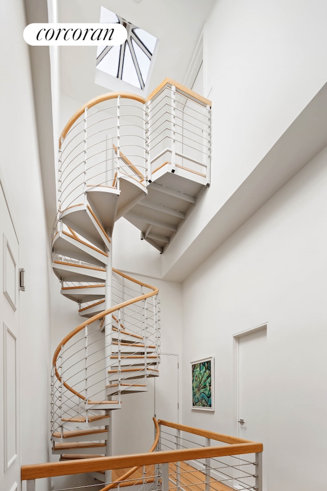 137 E 15th St Unit 2A, New York City, NY 10003 - stairs featuring a high ceiling and a skylight