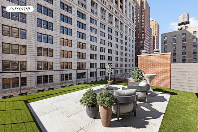 surrounding community featuring a view of city and a patio