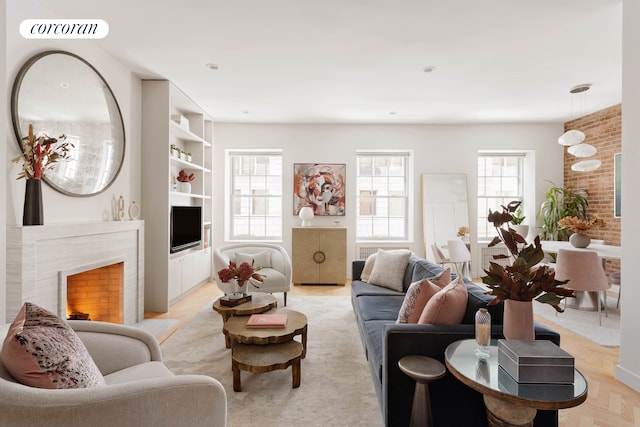 living area featuring visible vents, a high end fireplace, and built in features