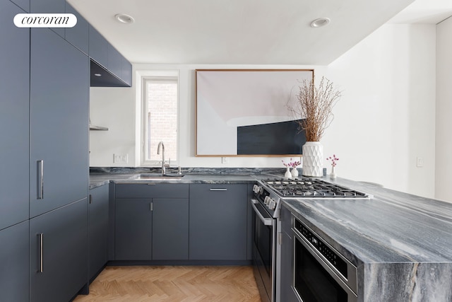 kitchen with a sink, a peninsula, and stainless steel gas stove