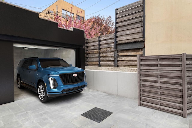 view of vehicle parking with fence