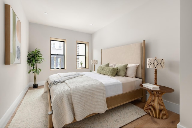 bedroom with baseboards and light wood-type flooring