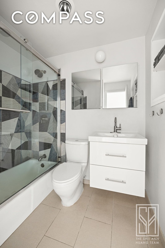 full bath featuring tile patterned flooring, combined bath / shower with glass door, toilet, and vanity